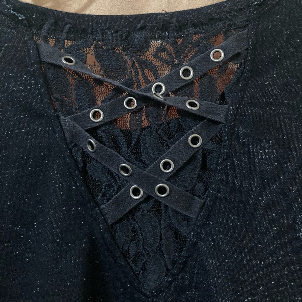 Distressed black long sleeved top with lace on back.